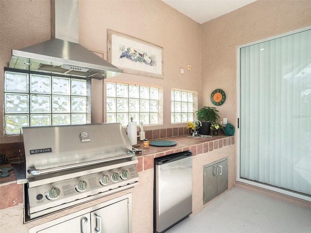 kitchen with island exhaust hood, refrigerator, and sink