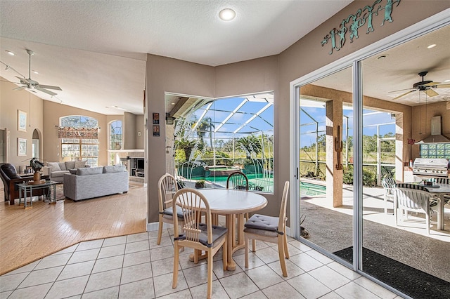 tiled dining area featuring a wealth of natural light and ceiling fan