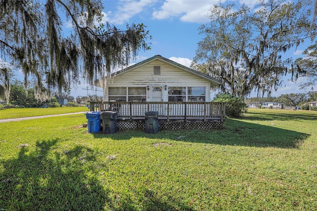 back of house with a yard and a deck