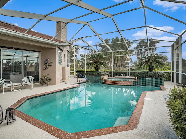 view of swimming pool featuring an in ground hot tub, a patio, and a lanai