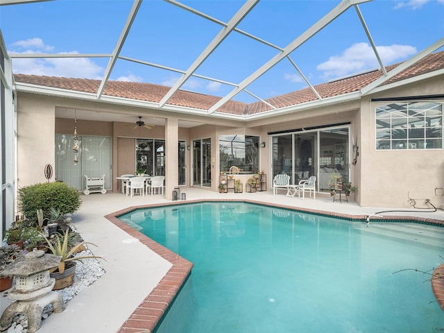 view of pool featuring ceiling fan, a lanai, and a patio