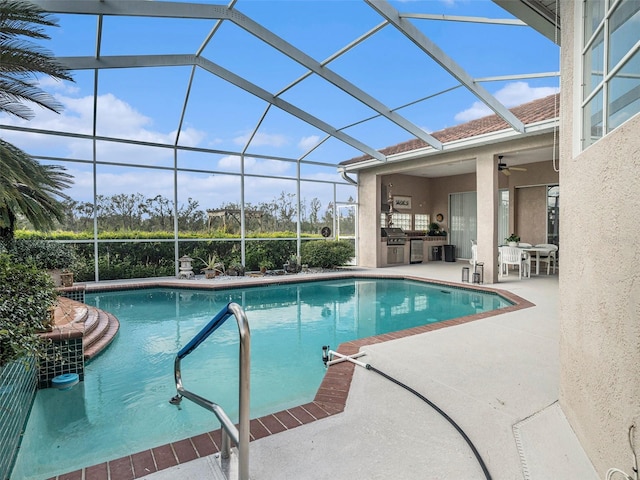 view of pool featuring ceiling fan, area for grilling, a patio area, and glass enclosure