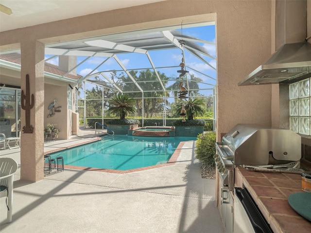 view of pool featuring an in ground hot tub, an outdoor kitchen, a lanai, grilling area, and a patio