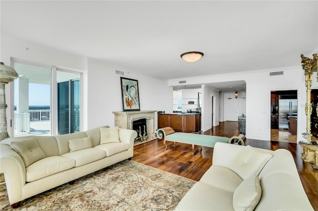 living room featuring hardwood / wood-style flooring and ornamental molding