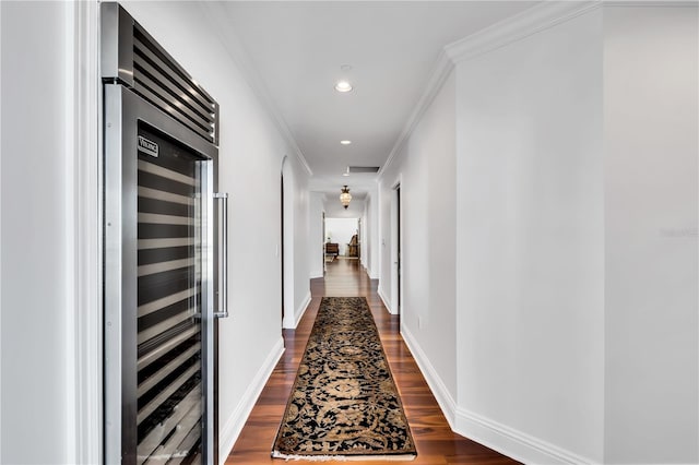 hall featuring crown molding, dark hardwood / wood-style flooring, and beverage cooler