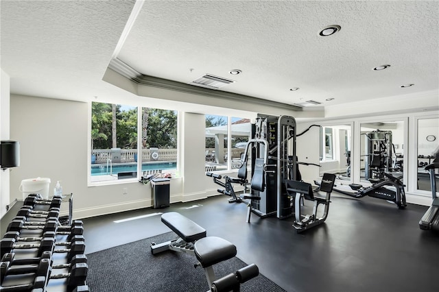 gym featuring ornamental molding and a textured ceiling