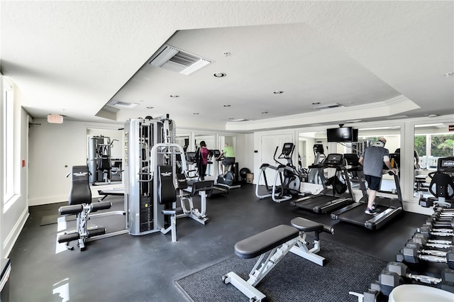 exercise room featuring a textured ceiling and crown molding