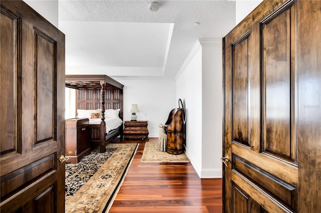 bedroom featuring dark hardwood / wood-style flooring and a textured ceiling