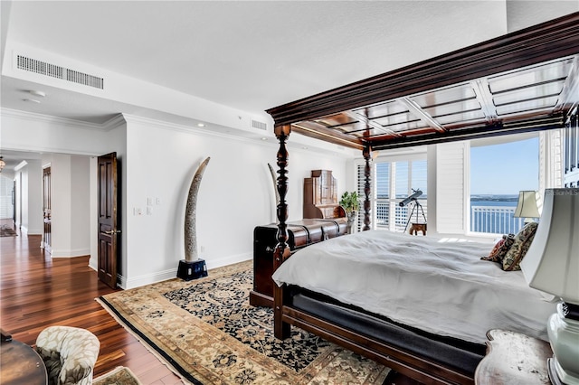 bedroom featuring ornamental molding, a water view, and dark hardwood / wood-style floors