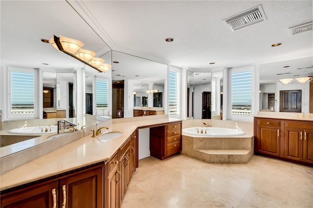 bathroom featuring vanity, crown molding, and tiled tub