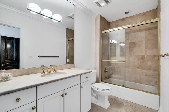 full bathroom with toilet, tile patterned floors, combined bath / shower with glass door, ornamental molding, and vanity