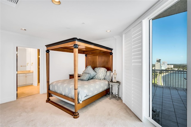 bedroom with ensuite bathroom, light colored carpet, and ornamental molding