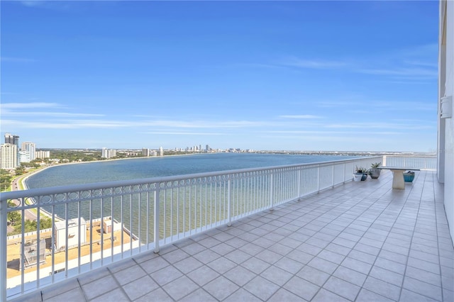 view of patio / terrace with a balcony and a water view