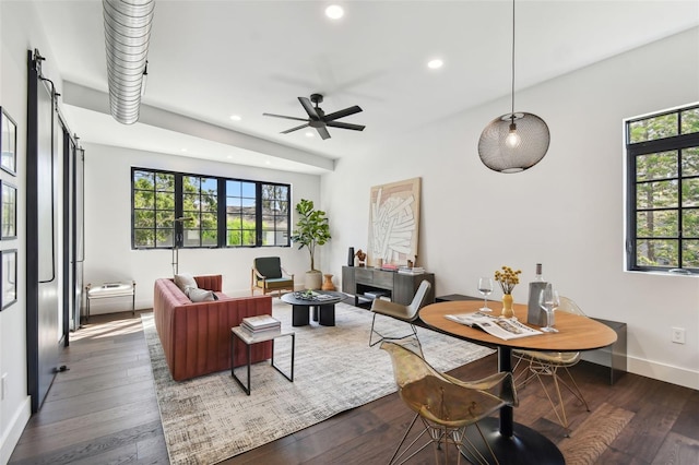 living room featuring ceiling fan and dark hardwood / wood-style flooring