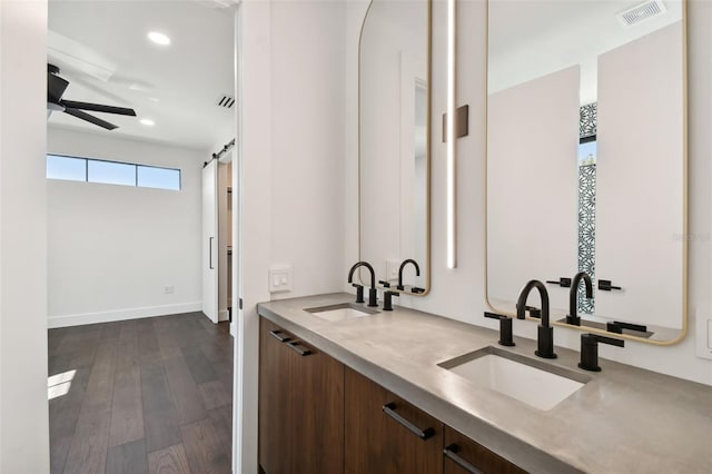 bathroom with vanity, hardwood / wood-style floors, and ceiling fan