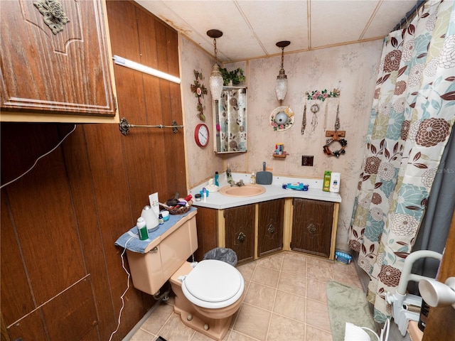 bathroom with toilet, large vanity, and tile flooring