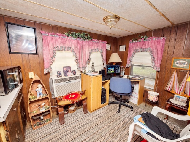 carpeted office space with wood walls, a textured ceiling, and a wall mounted AC