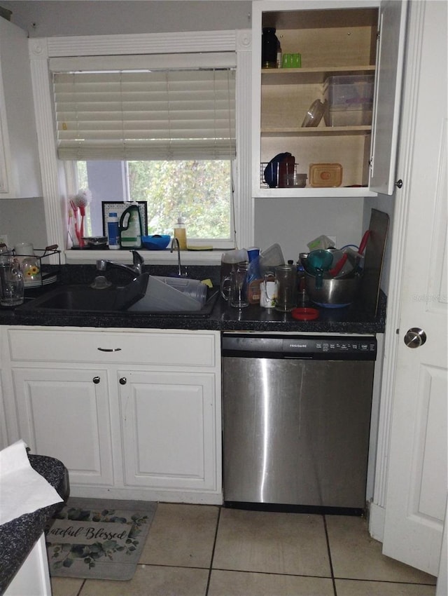 kitchen with light tile flooring, white cabinets, dishwasher, and sink