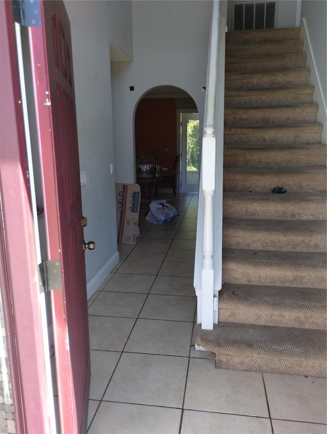 stairway with light tile floors