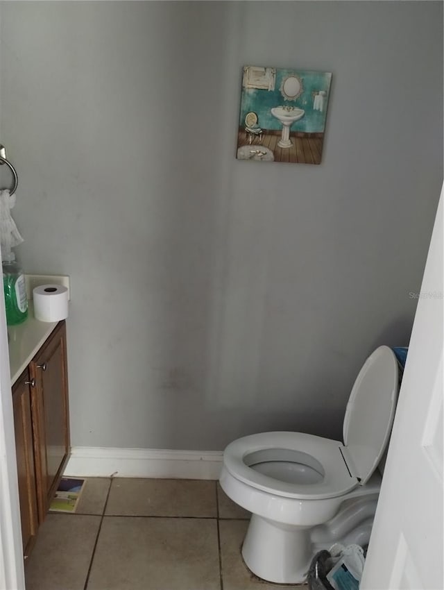 bathroom with vanity, tile floors, and toilet