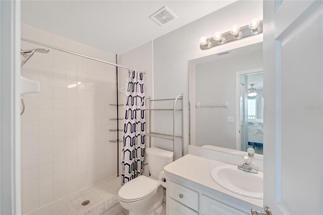 bathroom with walk in shower, vanity, and toilet