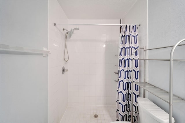 bathroom featuring curtained shower and toilet