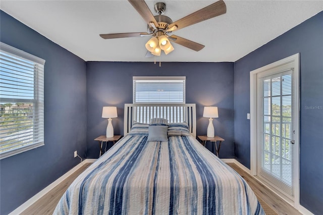 bedroom with light wood-type flooring and ceiling fan