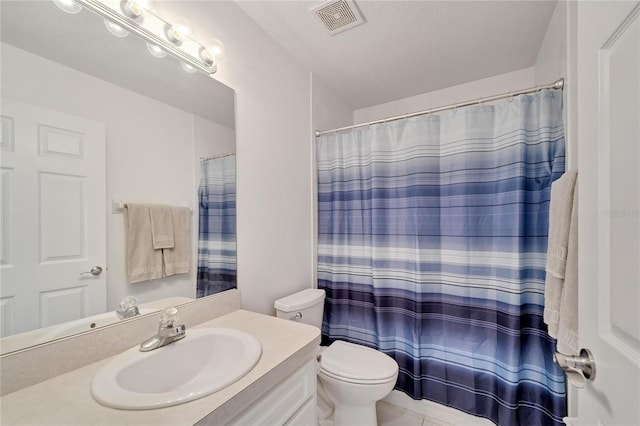 bathroom with walk in shower, tile patterned floors, toilet, a textured ceiling, and vanity