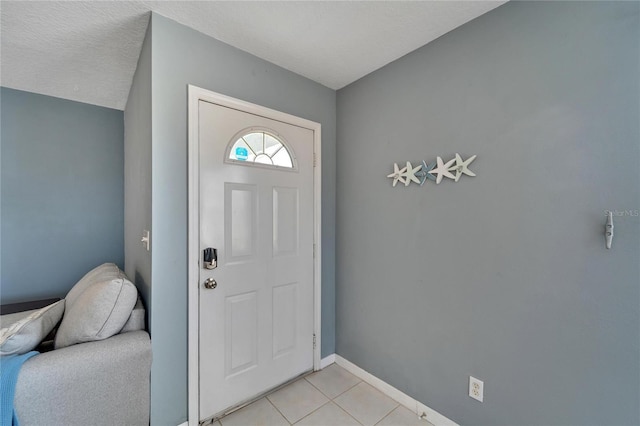 entrance foyer featuring light tile patterned floors and a textured ceiling