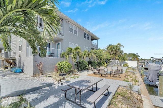 view of home's community featuring a patio and a deck with water view