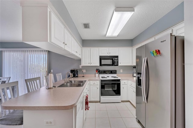 kitchen with white cabinetry, sink, a kitchen bar, kitchen peninsula, and white appliances