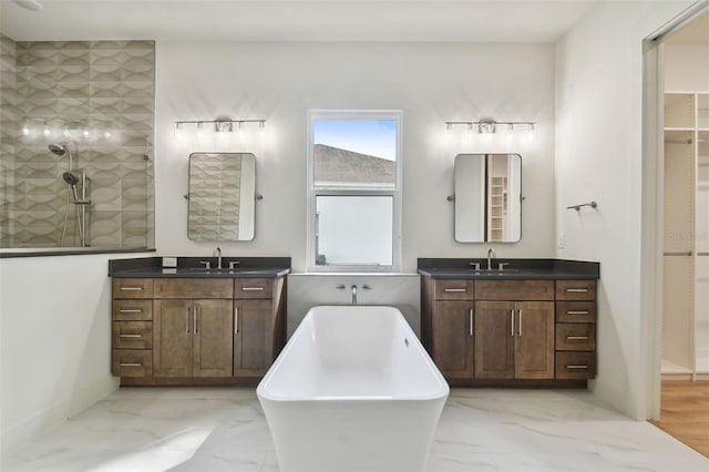 bathroom featuring separate shower and tub and vanity