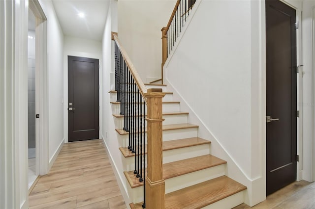 stairs with hardwood / wood-style floors