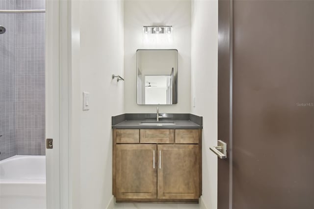 bathroom with vanity and tiled shower / bath combo