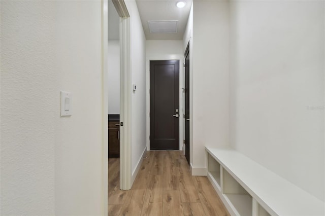 hallway with light hardwood / wood-style floors