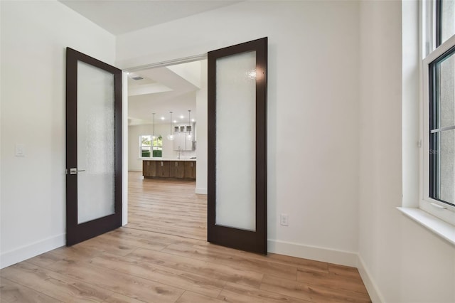 interior space featuring french doors and light wood-type flooring