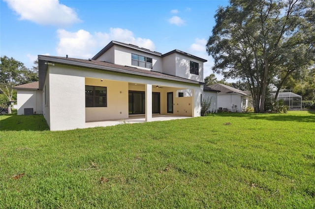 back of house with a lawn and a patio area