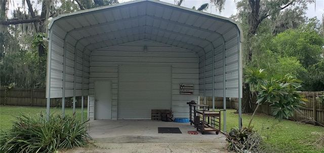 view of outbuilding with a yard and a carport