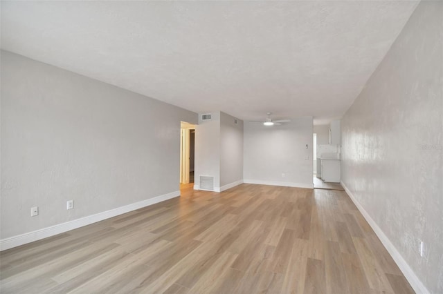 empty room featuring ceiling fan and light wood-type flooring