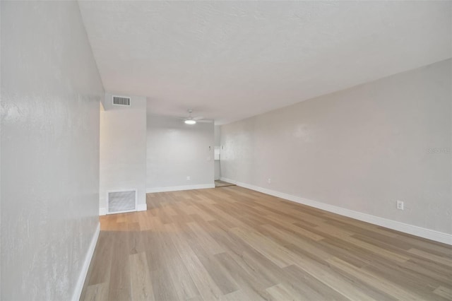 empty room featuring ceiling fan and light wood-type flooring