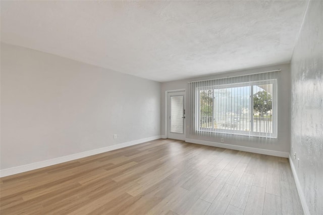 unfurnished room with light hardwood / wood-style floors