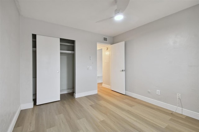 unfurnished bedroom with a closet, light hardwood / wood-style floors, and ceiling fan