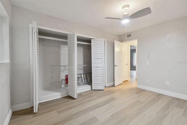 unfurnished bedroom with ceiling fan and light wood-type flooring