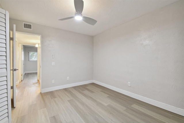 empty room with ceiling fan and light wood-type flooring