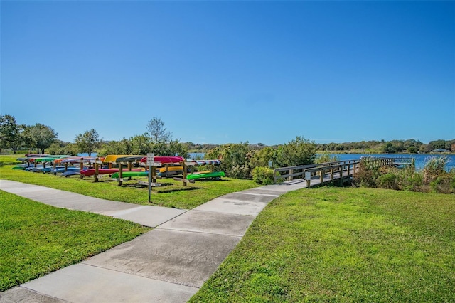 view of jungle gym with a water view and a yard