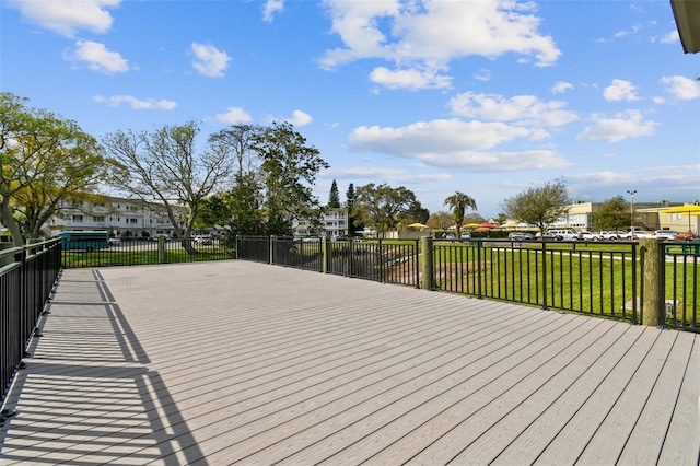 wooden terrace featuring a lawn