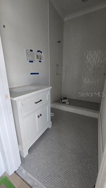 bathroom with vanity, tile patterned flooring, and ornamental molding