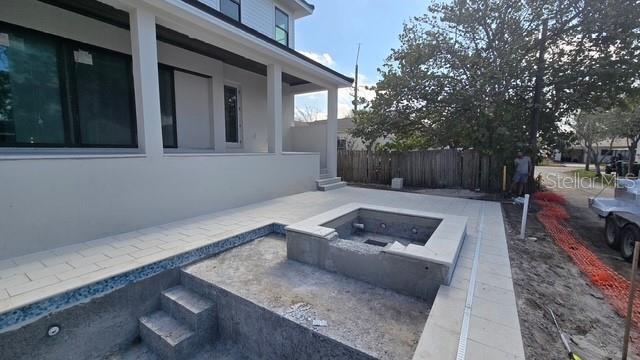 view of pool featuring an outdoor fire pit and fence