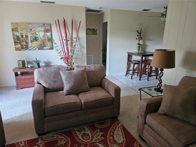 living room with light tile floors and ceiling fan