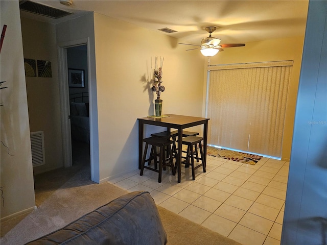 tiled dining room with ceiling fan